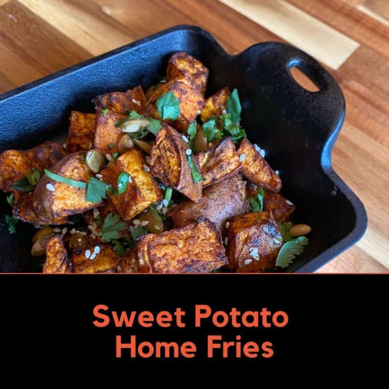 Seasoned Sweet Potatoes in a Cast Iron Dish on a Wood Table