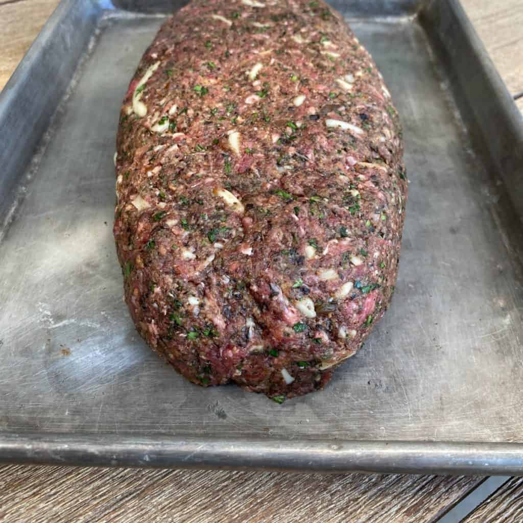 raw meatloaf on a tray
