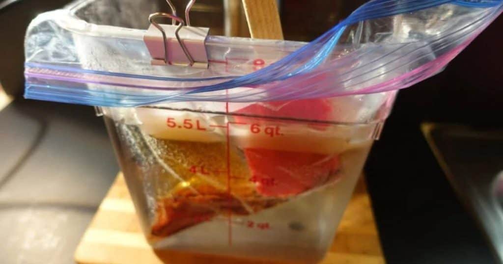 meat in a ziplock bag cooking in a sous vide waterbath