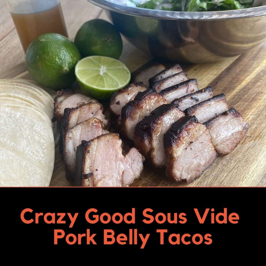 Sous Vide Pork Belly Sliced with tortillas, limes, chiipotle oil in a bottle and a bowl of arugula salad
